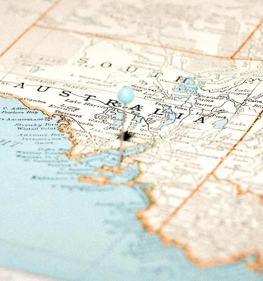 Close-up of a map focusing on South Australia, with a pin marking Port Adelaide. The map shows coastline and geographical details in muted blue and beige tones.